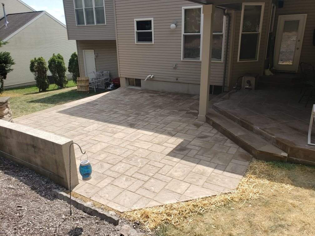 newly laid stone patio next to the covered porch