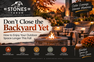 A Stone’s Throw fall outdoor living space with a stone fire pit, patio seating, landscape lighting and seasonal décor