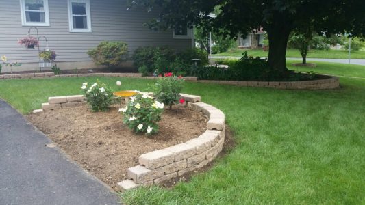 Retaining wall with landscaping along driveway Retaining wall with landscaping along driveway