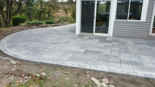 stone patio around back sunroom