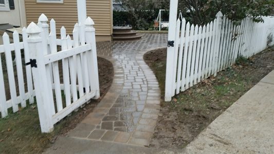 brick walkway through fence