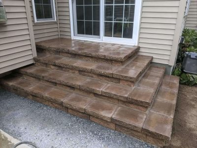 new dark brown stone steps from the sliding doors to the yard