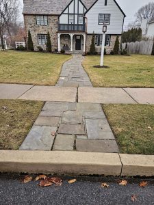 Before: stone walkway that meets the road Before: stone walkway with varying sizes that's become very worn and irregular