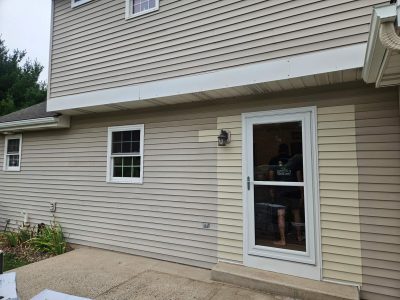old mismatching siding on the back patio of a house
