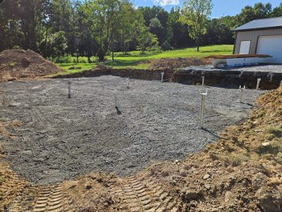 Custom patio and pergola installation in progress with paver construction underway